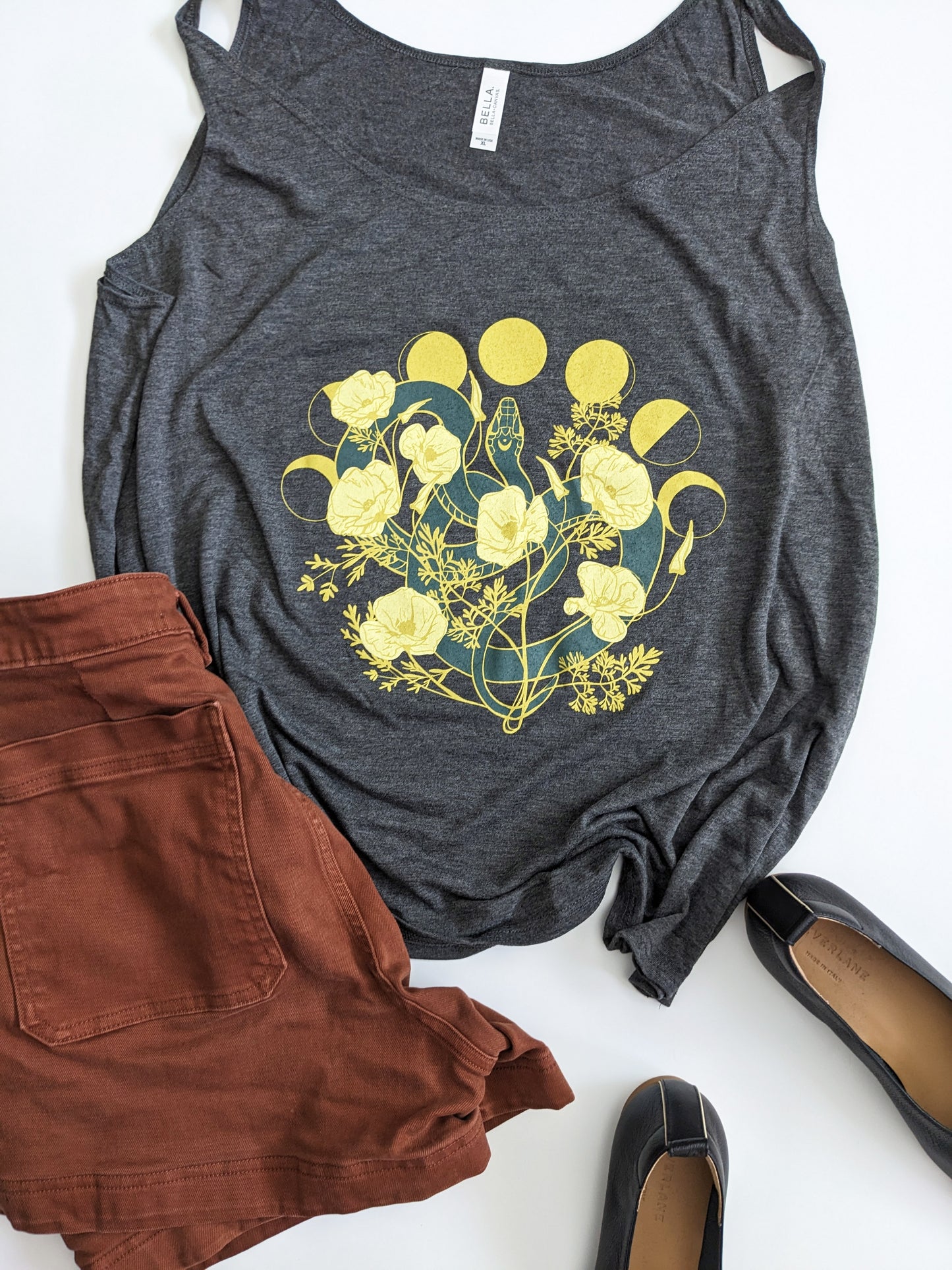 This super soft tank top features a snake among poppy flowers and the phases of the moon.